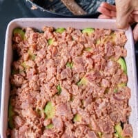 The sushi fish mixture is spread on top of the avocado layer in the baking pan and now it's ready to bake