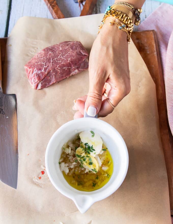 The dressing ingredients for the carpaccio in a small bowl