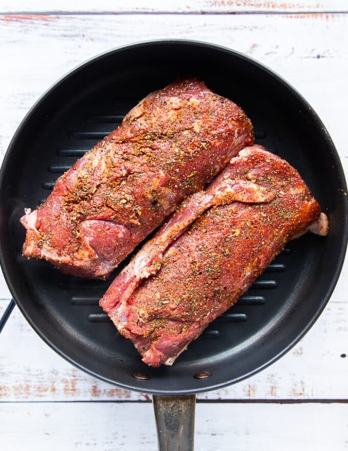The lamb loins in a grill pan to cook 