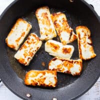 Golden pan fried halloumi cheese in a skillet