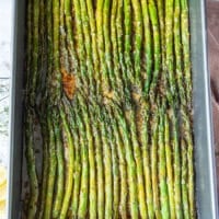 Asparagus perfectly roasted with a delicate golden crisp from the parmesan cheese ready out of the oven and still on the pan