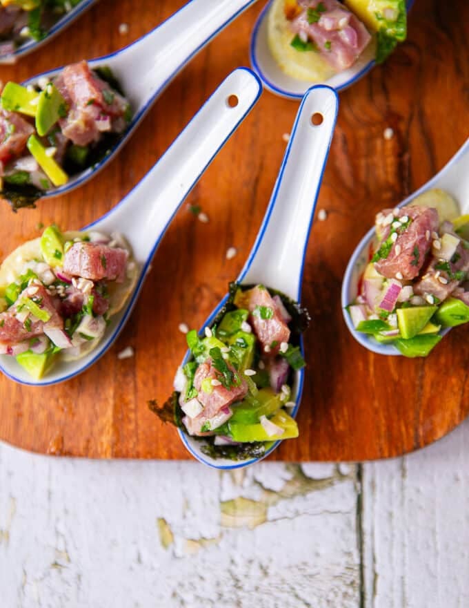 Close up of a few spoons of tuna ceviche with chips or seaweed