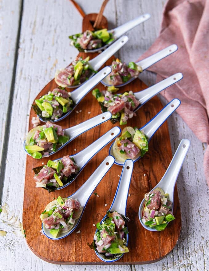 A full board with spoonful appetizers of tuna ceviche 