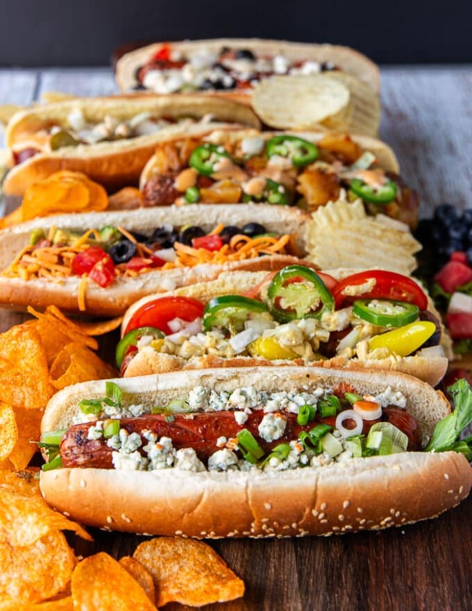 side view of the speciality grilled hot dogs made form the hot dog bar assembled on a board 