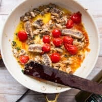 The sardines are then added here to the same skillet after the tomatoes have burst and the garlic has cooked