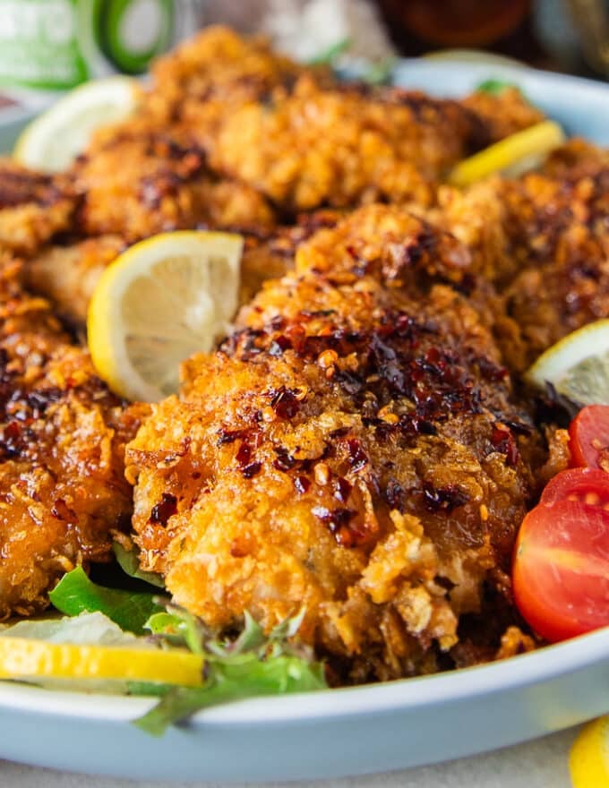 close up of one hot honey chicken tender dressed up with hot honey 