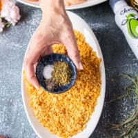The cornflakes plate being seasoned withe the spice blend in a shallow plate to prepare the coating