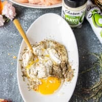 All the wet coating ingredients are added to a shallow plate with a fork used to mix them.