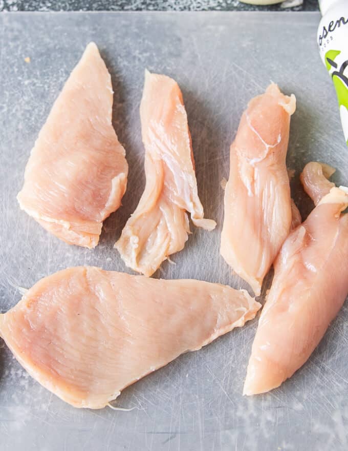 chicken tenders on a cutting board 