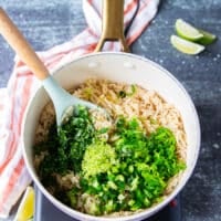 right over the cooked rice there's fresh cilantro, minced jalapeno, minced scallions, lime zest and lime juice and some olive oil added in the pot