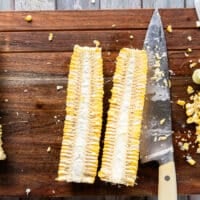 One corn on the cob cut in half lengthwise