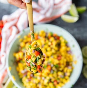 a spoonful of mango pico de gallo close up showing details of the pico