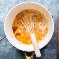 Milk is added to the pot for the queso recipe