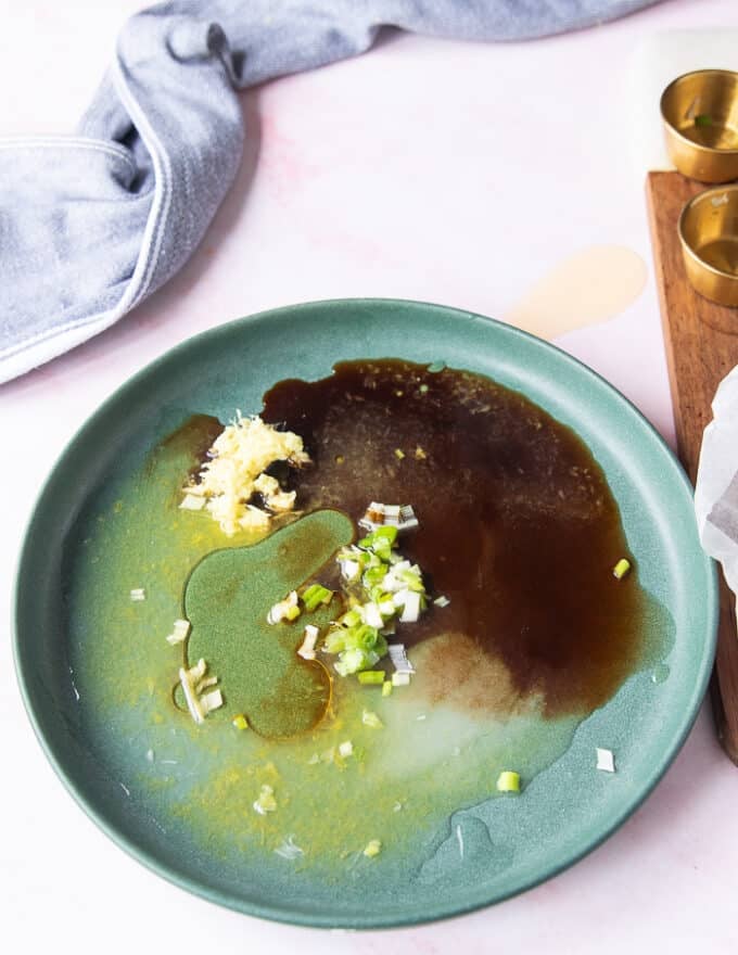 Ingredients for the ponzu sauce all added onto a serving plate