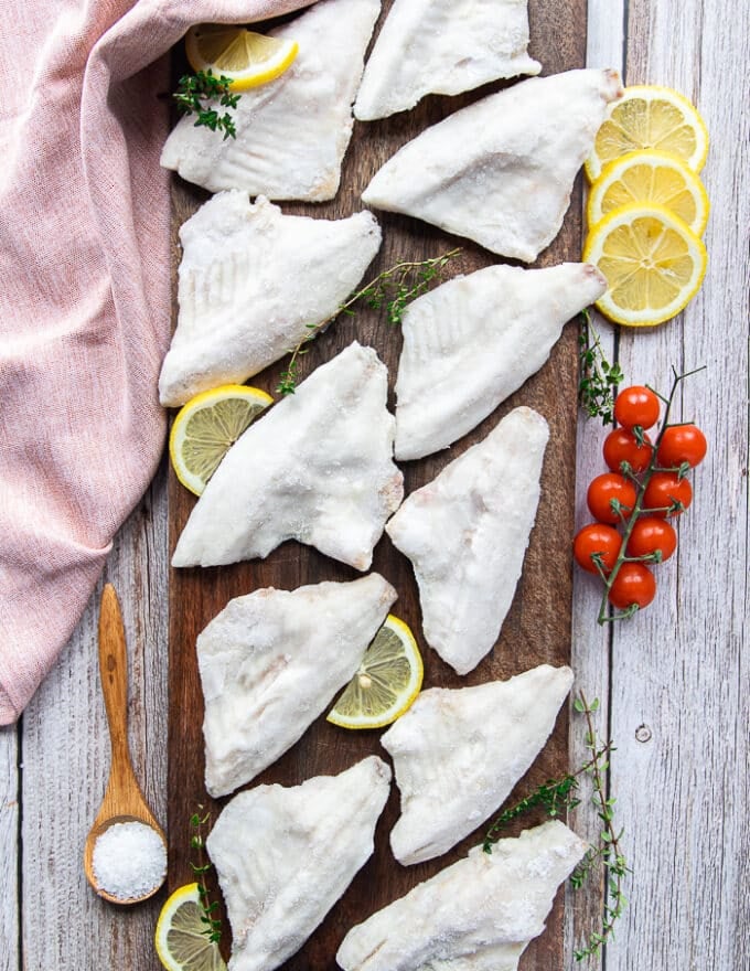 perch fillets on a wooden board showing the fish in details 