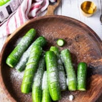 Salt added to the cut up cucumbers in a large bowl