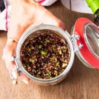 All chili oil ingreidnets are added into a wide mouth jar like salt, sugar, chilli flakes, ginger, garlic, scallions