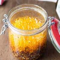 A close up of the bubbling hot oil in the jar as it hits the chilli powder and other ingredients