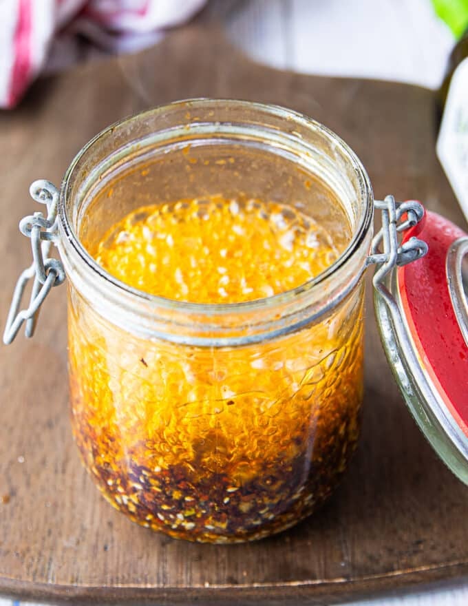 A close up of the bubbling hot oil in the jar as it hits the chilli powder and other ingredients