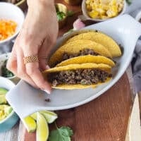 the ground beef is now added over the cheese in the taco shell