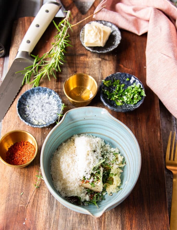 garlic butter ingredients all added into the bowl including the soft butter, fresh garlic, herbs and seasoning 