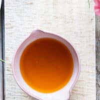 A bowl with the strained butter sauce looking like liquid gold