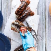 A hand pulling out the meat entirely out of the shell
