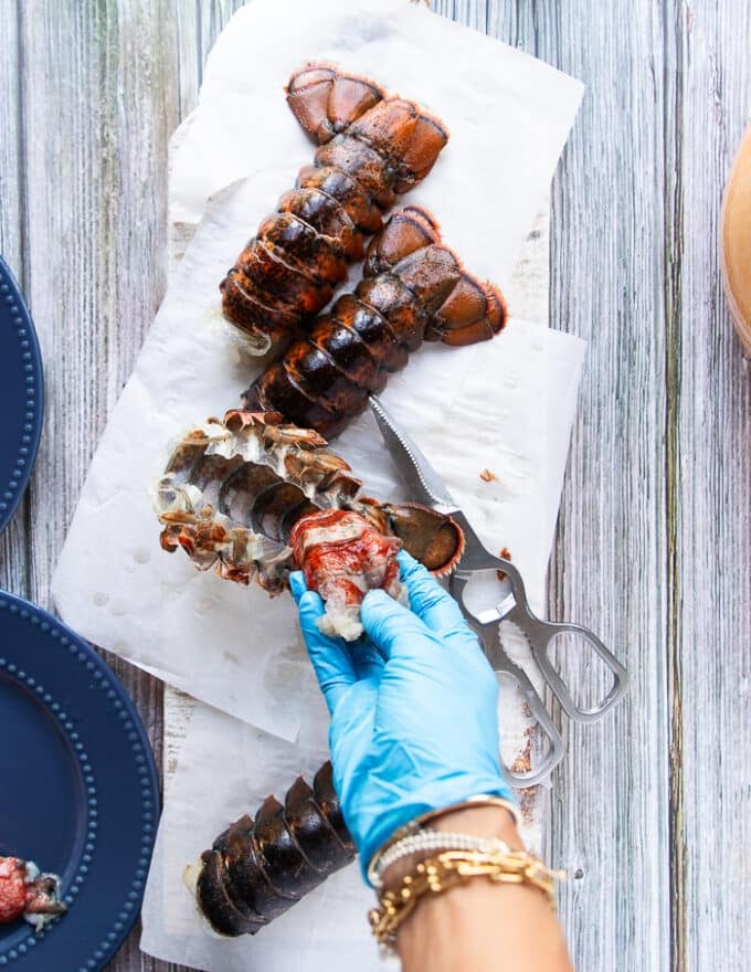 A hand pulling out the meat entirely out of the shell