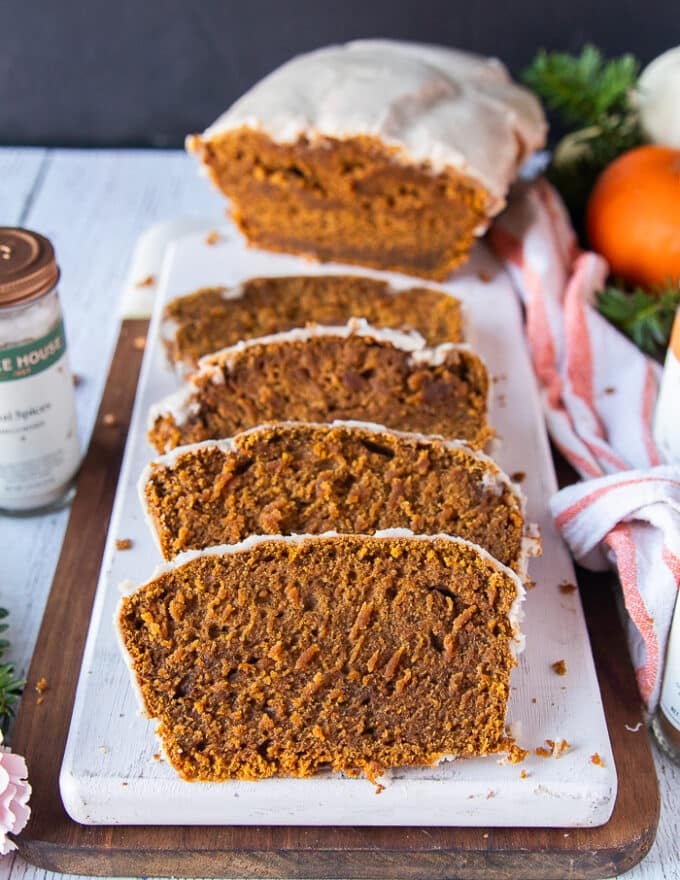 sliced pumpkin bread on a white board showing the texture and moist crumb close up 