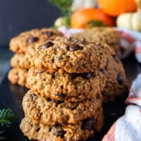 Stack of 5 pumpkin oatmeal cookies on top of each other showing the thickness, texture and chewy cookies studded with chocolate chips