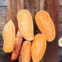 sweet potatoes cut in half on a wooden board