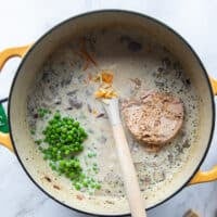 The tuna, green peas and cheese are added to the pot once the sauce has boiled