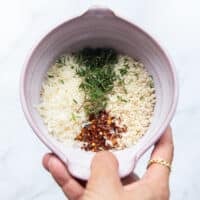 topping ingredients all mixed in a bowl which is panko bread crumbs, thyme, chilli flakes lemon zest