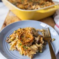 A plate with a serving of tuna casserole and a fork next to it
