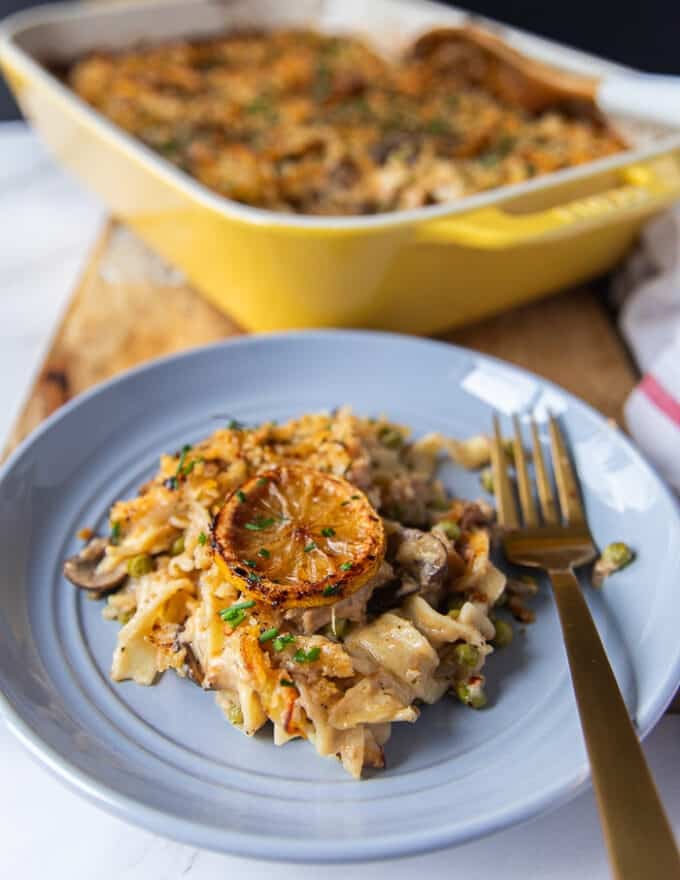 A plate with a serving of tuna casserole and a fork next to it