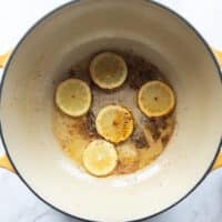 lemon slices caramelizing in the bottom of the pot