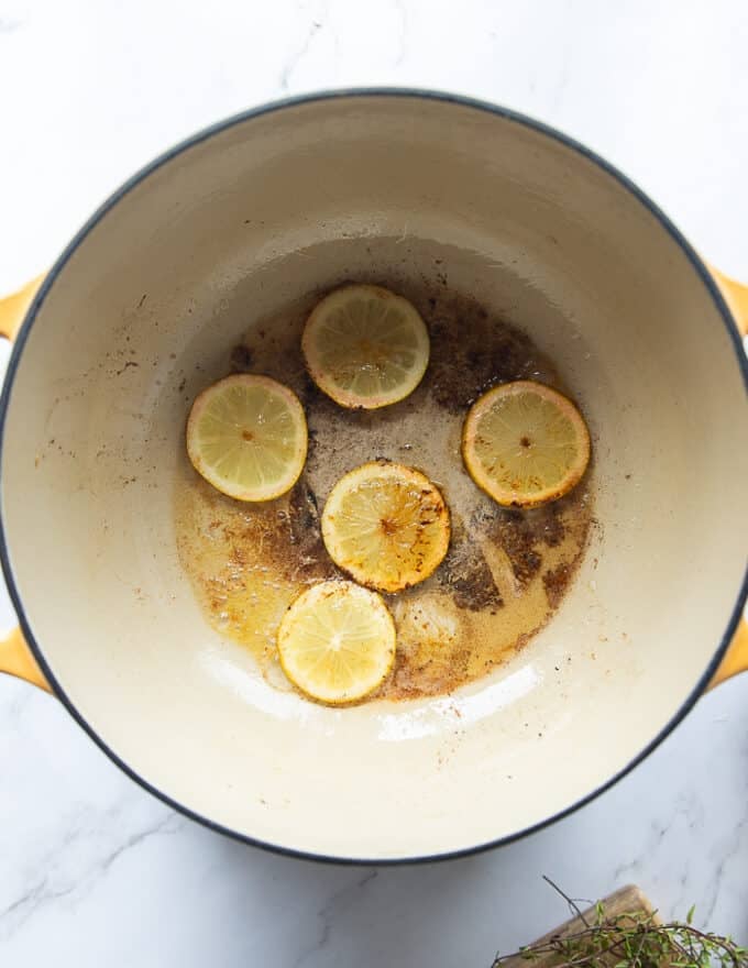lemon slices caramelizing in the bottom of the pot
