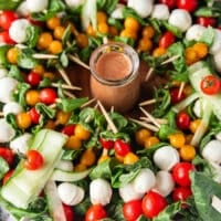 The full caprese wreath with a jar of dressing in the middle
