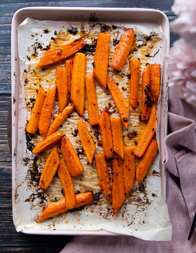 Roasted carrots out of the oven, golden, tender and ready for the other half of the glaze 