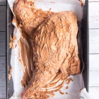 The whole shoulder of lamb slathered in the marinade