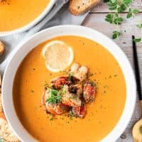 close up of a lobster bisque bowl finished with chunks of succulent lobster