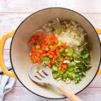 the mirepoix ingredients all added in a pot along with the flavored butter