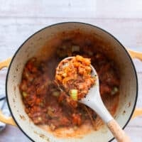 tomatoes are added to the pot and cooked until thickened