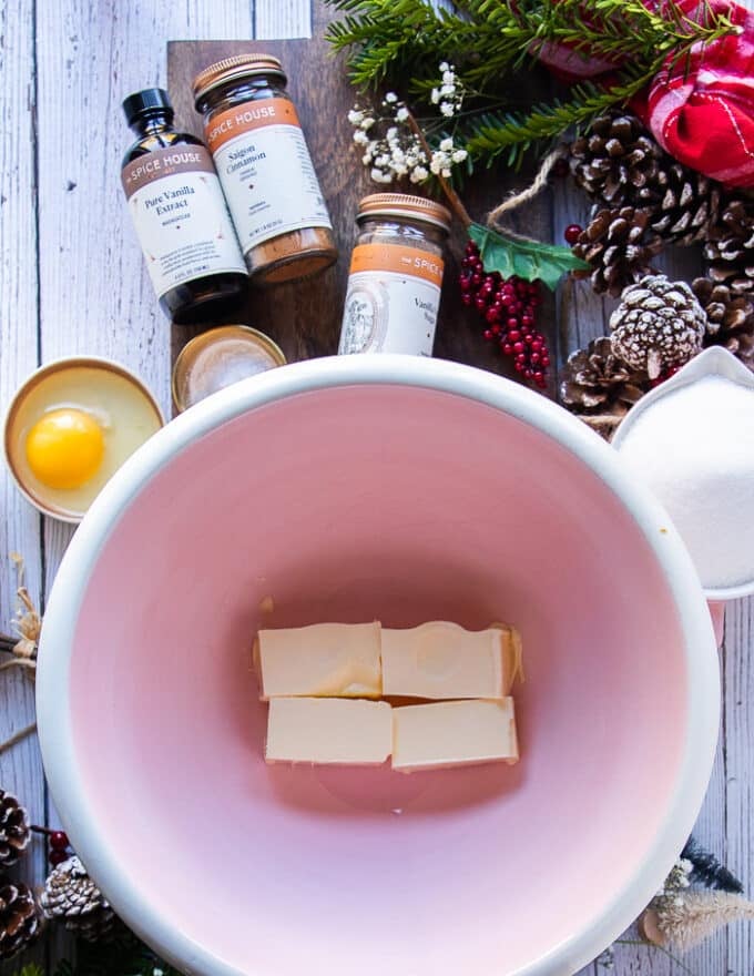 ingredients for sugar cookie recipe including soft butter, some vanilla bean sugar, vanilla extract, pinch of salt, an egg in a bowl, some flour in a bowl and cornstarch in a small bowl , baking powder in a small bowl