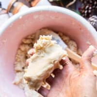 A hand holding the sugar cookie dough when finished to show the texture of the soft dough, not sticky and not dry, but rather soft