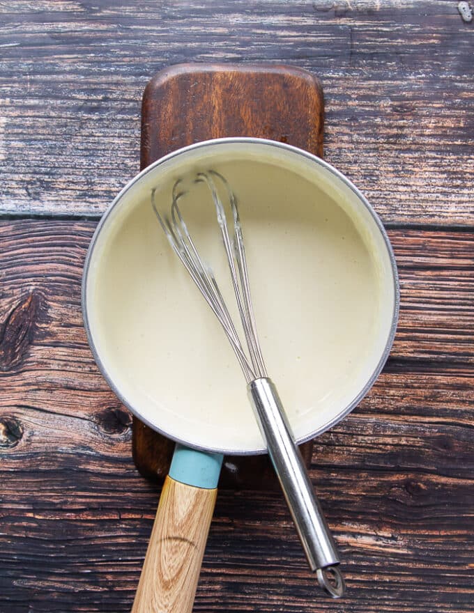The butter and flour cooking in a pot as a base to the sauce for cauliflower casserole 