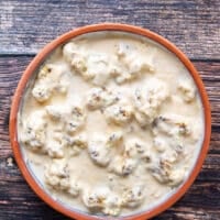 The sauce is spread right over the cauliflower florets in the casserole dish