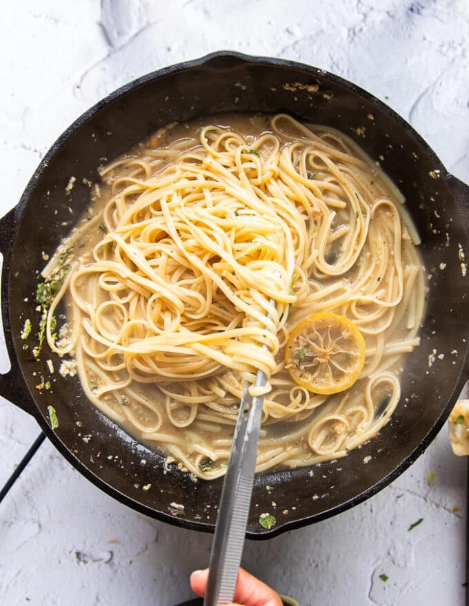 cooked linguine is added to the sauce skillet and tossed well.