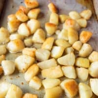 halfway roasted crispy potatoes being tossed around for ven browning