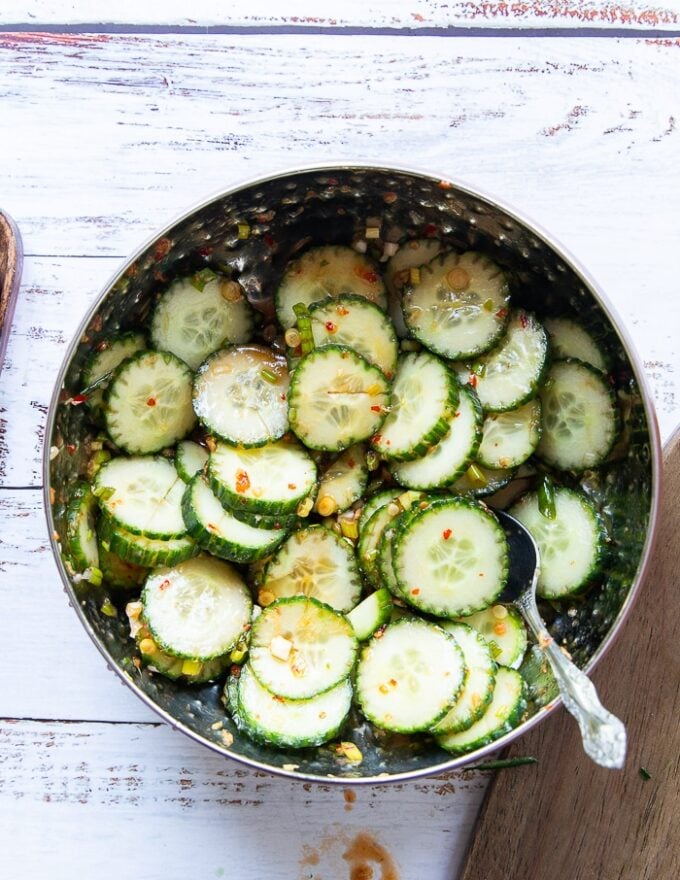 The easy cucumber salad is now tossed with the dressing a bowl 